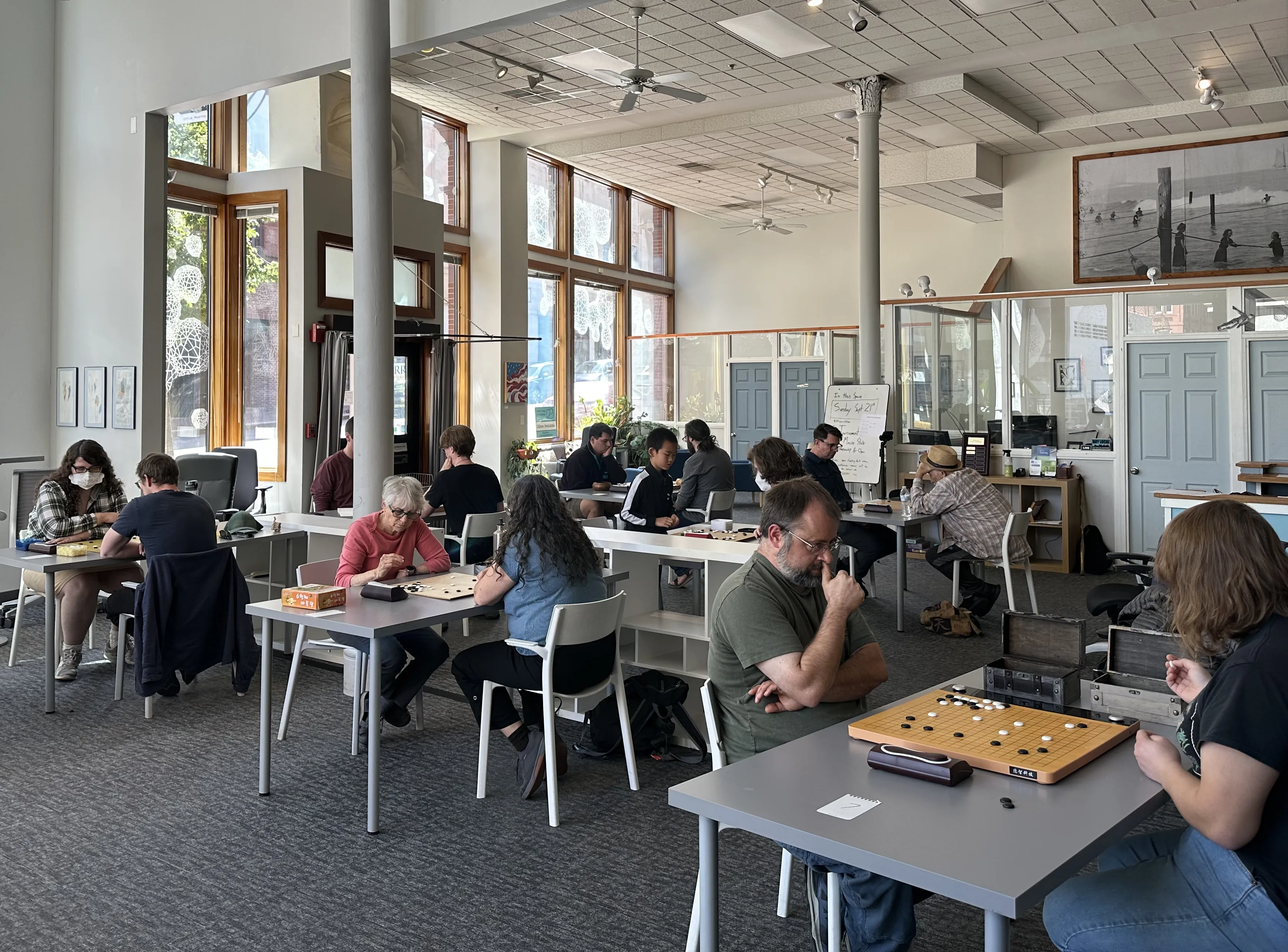 Round two of the tournament in session; a room full of people playing Go.